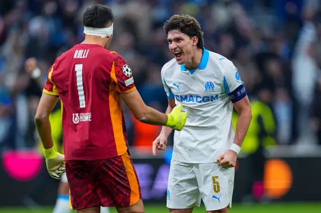 Geronimo Rulli of Marseille celebrates victory at full-time with Leonardo Balerdi