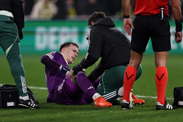Marco Bizot of Aston Villa receives medical treatment