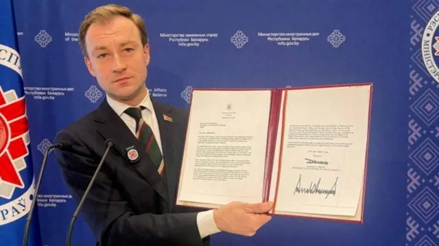 Belarus's Foreign Ministry spokesman Ruslan Varankov shows a letter from Donald Trump inviting Belarus's President Alexander Lukashenko to join the "Board of Peace", in an image released on Monday