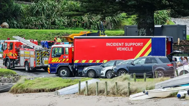 Large red emergency trucks parked on a road