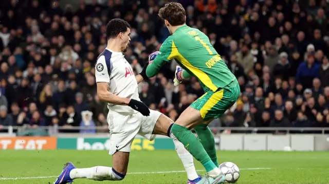 Dominic Solanke pokes the ball beyond Borussia Dortmund's goalkeeper