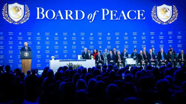 Trump speaks at the 'Board of Peace' meeting in Davos with members of the board sat to the side of him