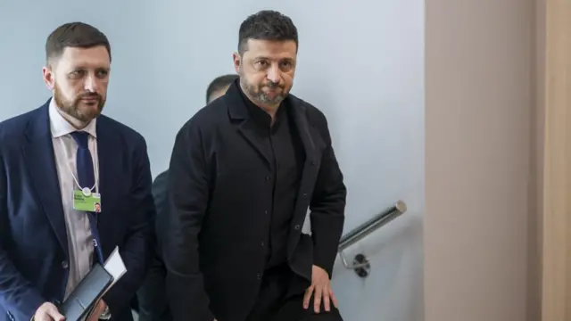 Ukraine's President Volodymyr Zelensky walks in the corridor as he arrives to speak at the World Economic Forum in Davos