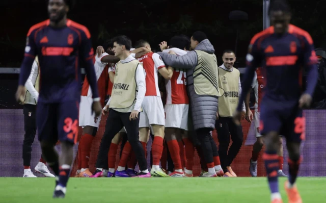 S.C. Braga players celebrate their first goal, an own goal scored by Nottingham Forest's Ryan Yates