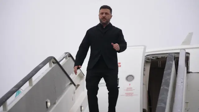 Zelensky coming off of his plane, walking down to ground level.