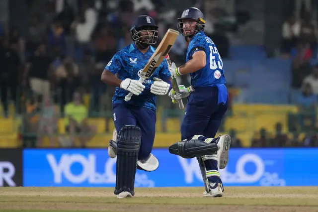Rehan Ahmed (L) and Jos Buttler (R) of England takes a single