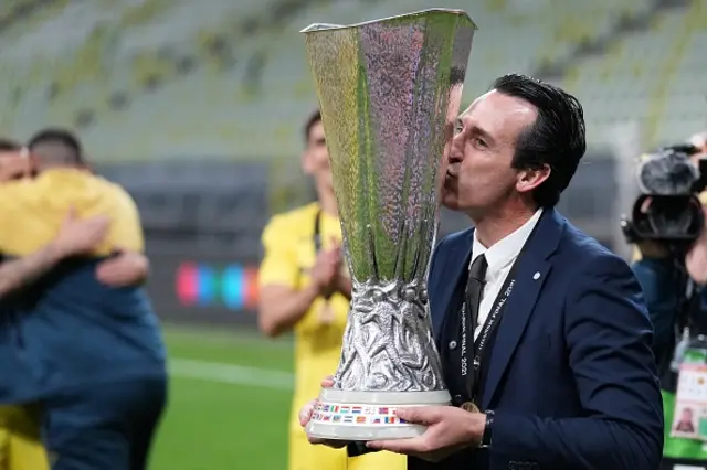 Ex-Villarreal's Spanish coach Unai Emery kisses the trophy as he celebrates