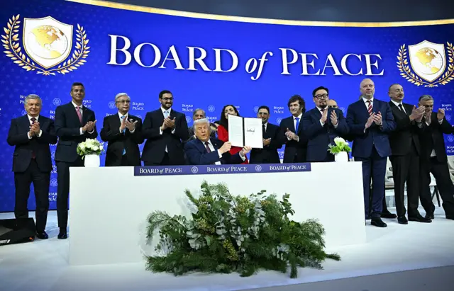 World leaders and politicians with President Trump at the Board of Peace signing ceremony.