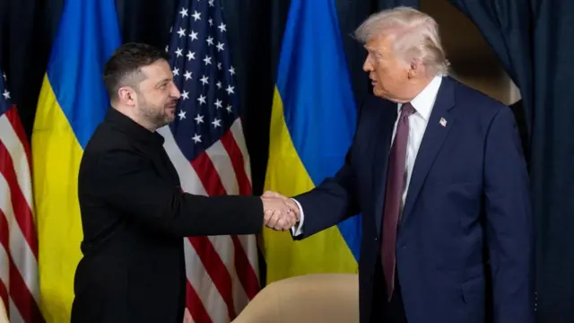 Zelensky and Trump shake hands in front of US and Ukranian flags
