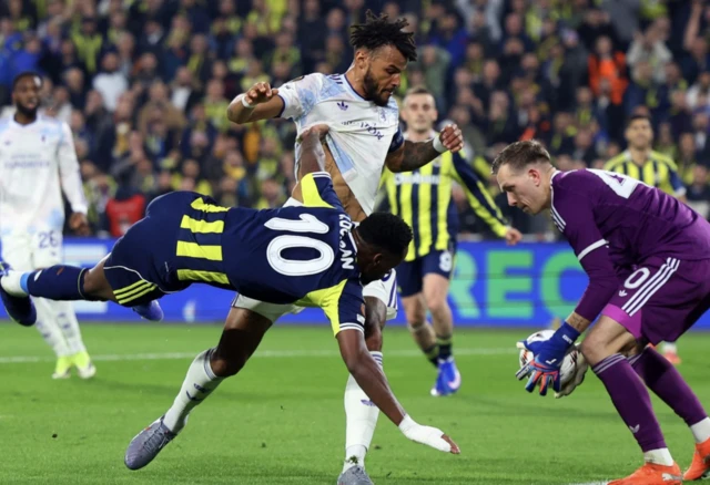 Fenerbahce's Jhon Duran in action with Aston Villa's Tyrone Mings as Marco Bizot makes a save