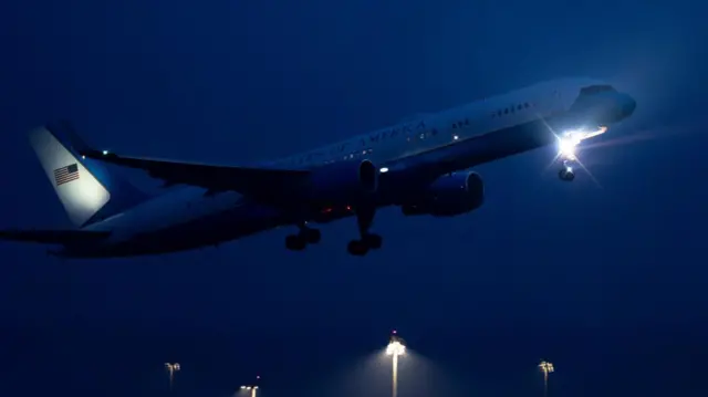 Plane flying above airport.
