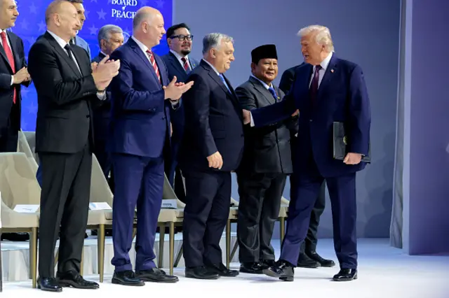 Donald Trump on stage with other world leaders.