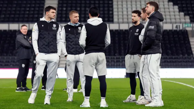 West Brom's players inspect the pitch at Pride Park before their game against Derby