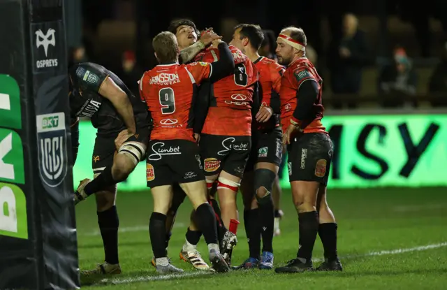 Lions players celebrate their try