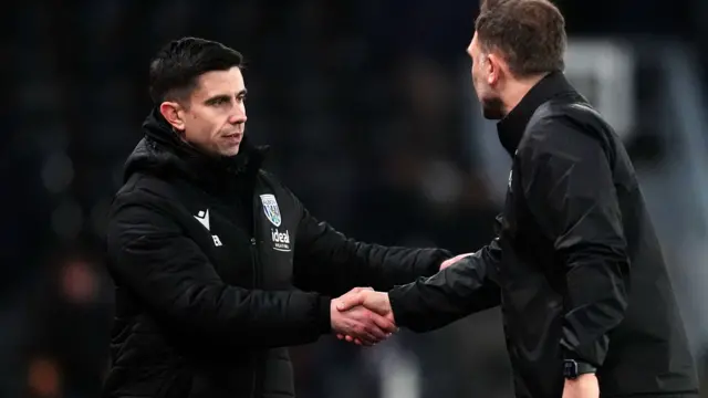 Eric Ramsay shakes hands with John Eustace