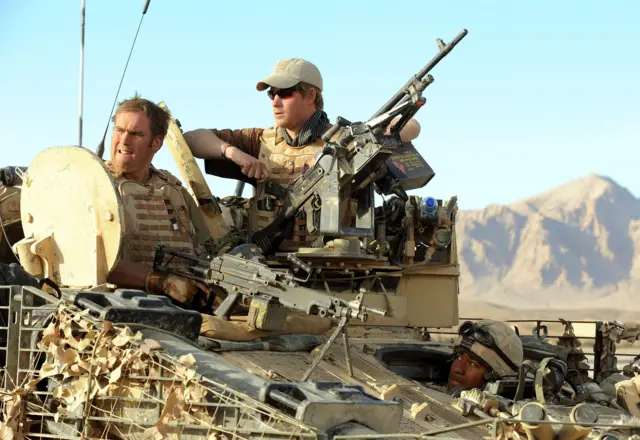 Prince Harry sits with Lance Cpl of Horse Chris 'Dougie' Douglass atop a spartan armoured vehicle in Helmand Province
