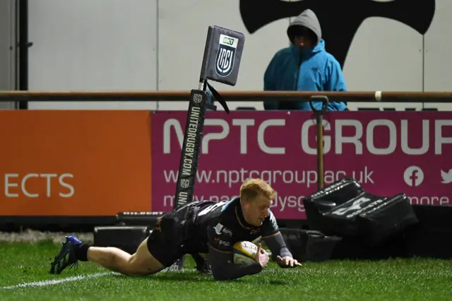 Iestyn Hopkins of Ospreys dives in to score a try