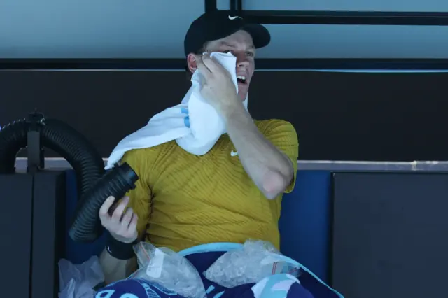 Jannik Sinner uses ice, towels and an air conditioning unit to try to cool himself down