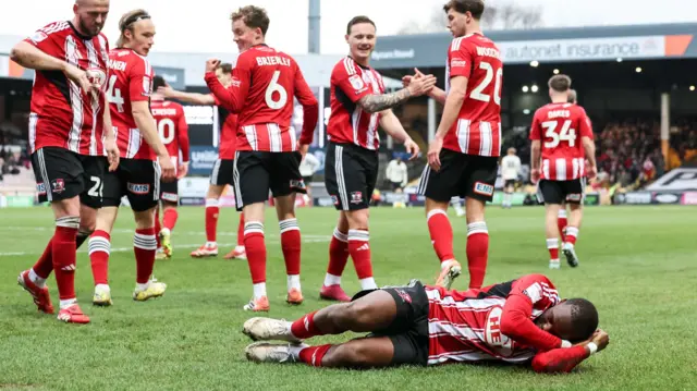 Exeter City players celebrate a goal