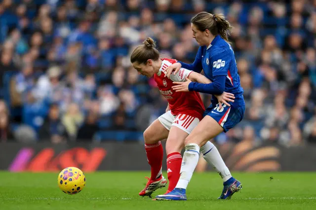 Kim Little holds off the challenge of Wieke Kaptein