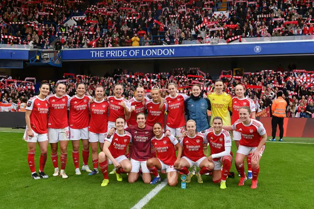 Arsenal players pose for a picture in front of the away fans