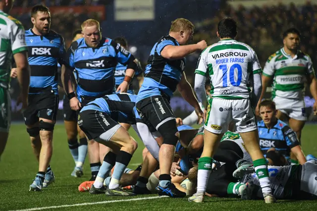 Cardiff players celebrate Josh McNally's (hidden) try