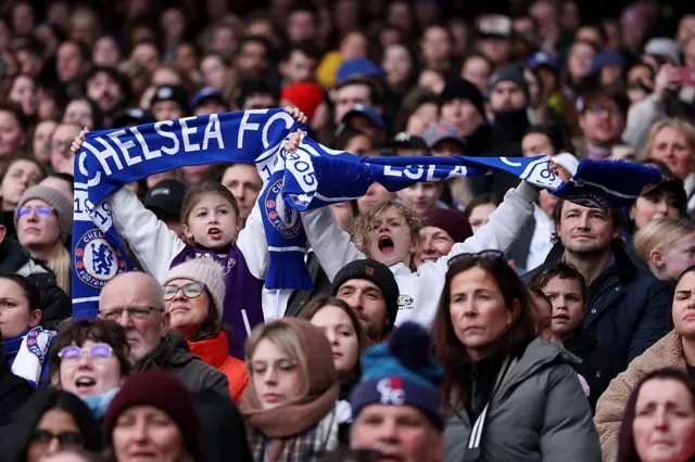 Chelsea fans hold up scarves