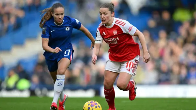 Kim Little on the ball, with Guro Reiten in pursuit
