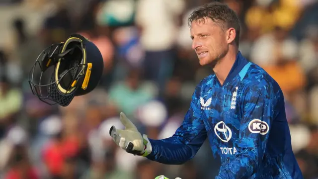 Jos Buttler catching his helmet