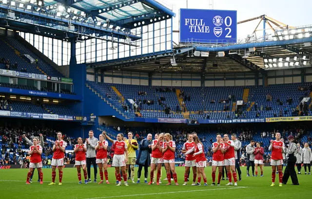 Arsenal players interact with the away end