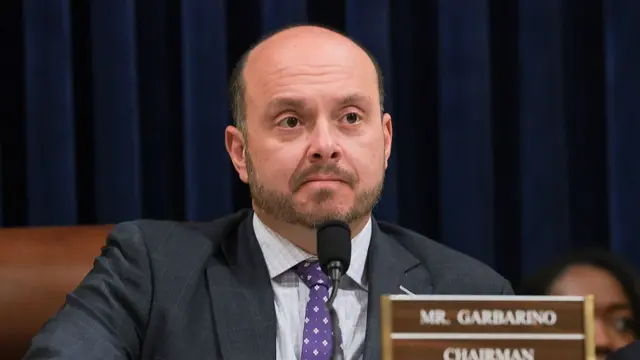 Garbarino speaking into mic