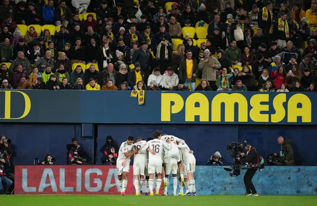 Real Madrid players celebrate together after Kylian Mbappe's penalty