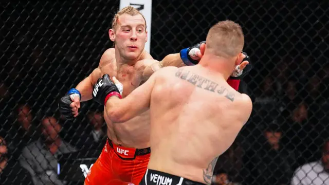 Paddy Pimblett of England punches Justin Gaethje
