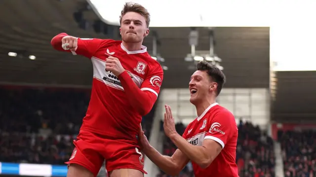 Tommy Conway of Middlesbrough celebrates scoring his team's fourth goal against Preston with teammate Dael Fry