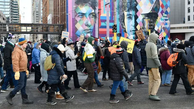 Protesters march with placards in downtown Minneapolis