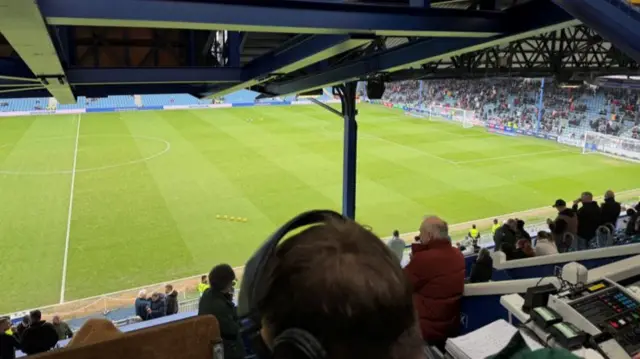 A photo from inside the commentary box looking out onto the ground at Fratton Park