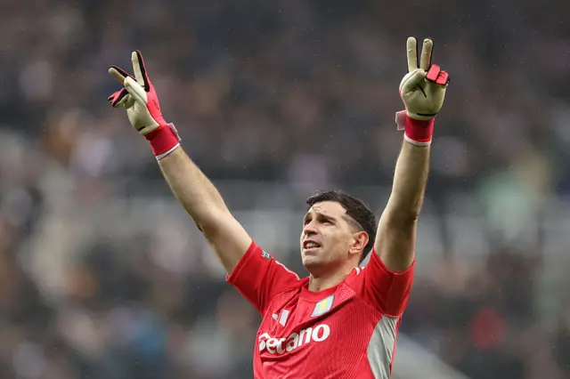 Emiliano Martinez with his hands in the air