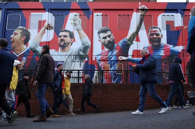 Fans arrive ahead of the English Premier League football match between Crystal Palace and Chelsea at Selhurst Park
