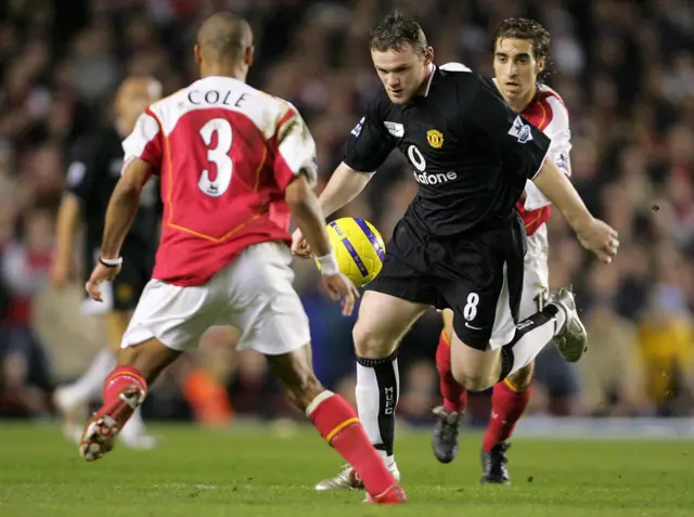 Manchester United's Wayne Rooney runs at Arsenal's Ashley Cole