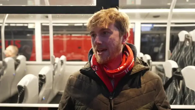 A man wearing a red scarf.
