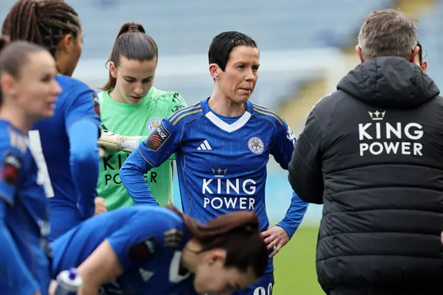 Ash Neville listens to a team talk