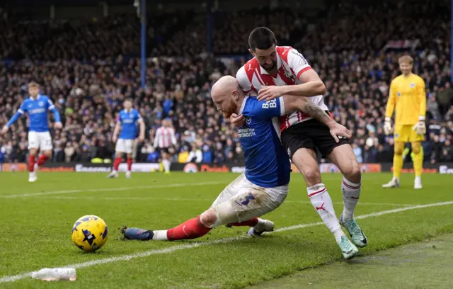 Portsmouth's Connor Ogilvie (left) and Southampton's Finn Azaz battle for the ball