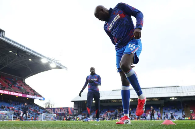 Jean-Philippe Mateta (R) warms up ahead