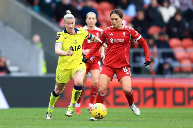 Fuka Nagano on the ball with Bethany England in pursuit