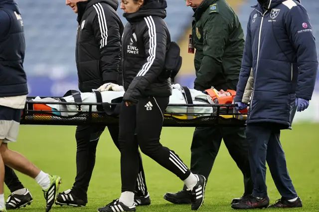 Kinga Szemik is carried on a stretcher