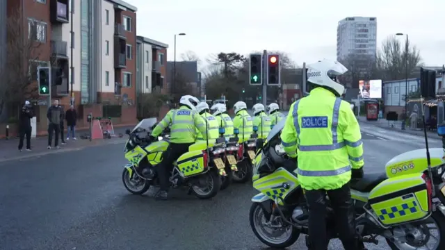 A line of police on motorcycles.