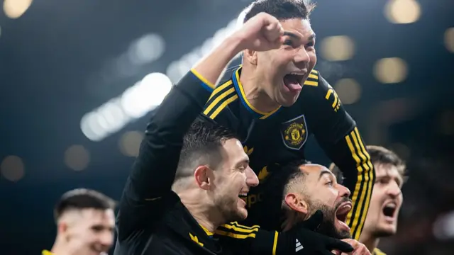 Manchester united players celebrating the third goal