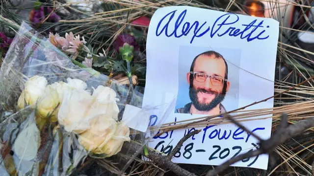 Flowers are left at a makeshift memorial in the area where Alex Pretti was shot dead