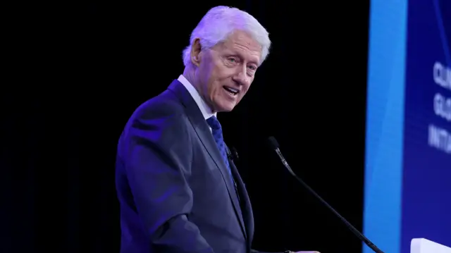 Former US President Bill Clinton speaks into a microphone.