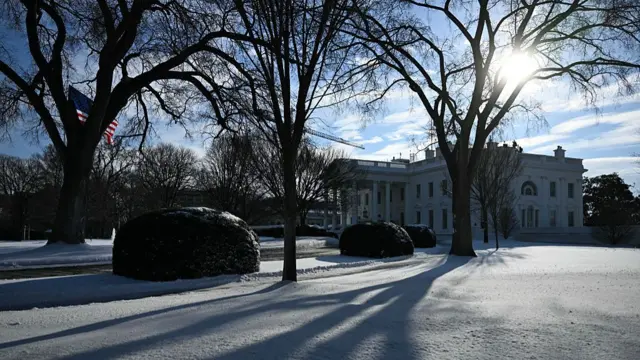 The White House, its grounds are covered in snow